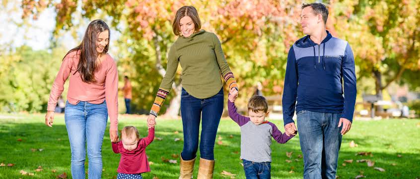 "Au pair playing with children outdoors in Canada during summer"